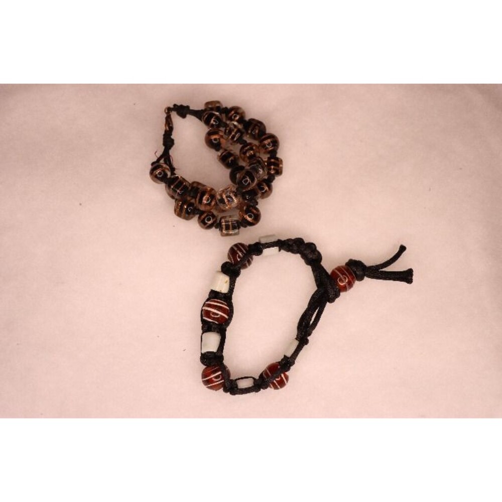 Set of two corded beaded braided bracelets in brown earth tones